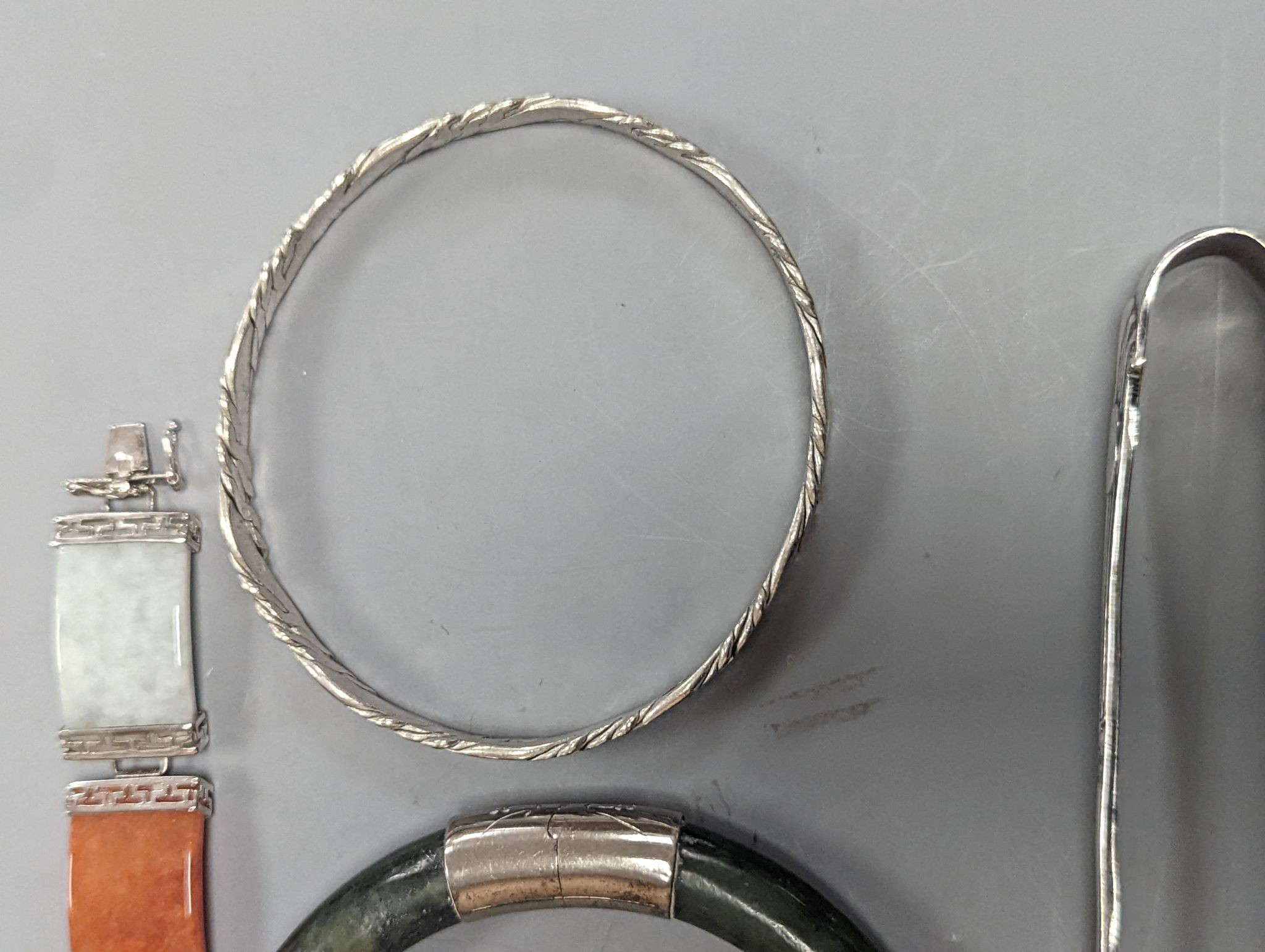 A 925 and hardstone set bracelet, 19.7cm, one other bracelet, two cameo shell brooches, three assorted bangles and a pair of sugar tongs.